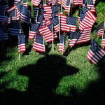 remembrance ceremony American flags, each representing firefighters lost during 9/11 and every year since, poke up from the ground near the shadow of an Augusta-Richmond Sheriff's Deputy during the 9/11 10th Anniversary Remembrance Ceremony at the Augusta Common in Augusta Sunday afternoon September 11, 2011. Michael Holahan/Staff